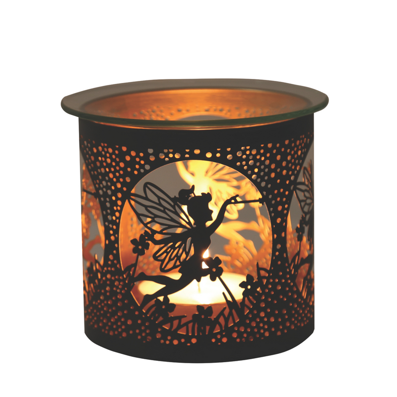 A black metal candle holder with intricate fairy cutouts, casting warm, glowing light. The fairies appear to dance among flowers, creating a whimsical mood.