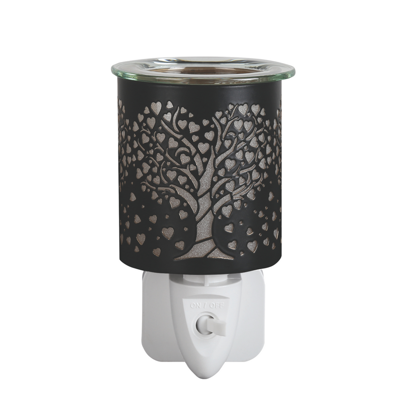 Black electric wax warmer with a tree of hearts design on a white plug-in base. The intricate cutout creates a cozy, inviting glow.