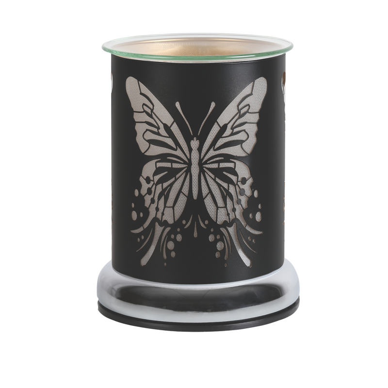 A decorative black metal cylindrical electric wax melt warmer featuring a butterfly cutout design. The warm light creates an elegant and soothing ambiance.