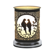 A decorative black electric wax melt warmer features two silhouetted birds on a branch, enclosed in a circular frame. Warm light glows, creating a cosy, romantic ambiance.