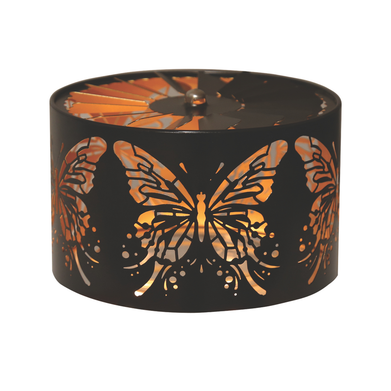 A black, cylindrical spinning candle carousel holder features intricate butterfly cutouts. Warm, glowing light shines through, creating a cozy and serene atmosphere.