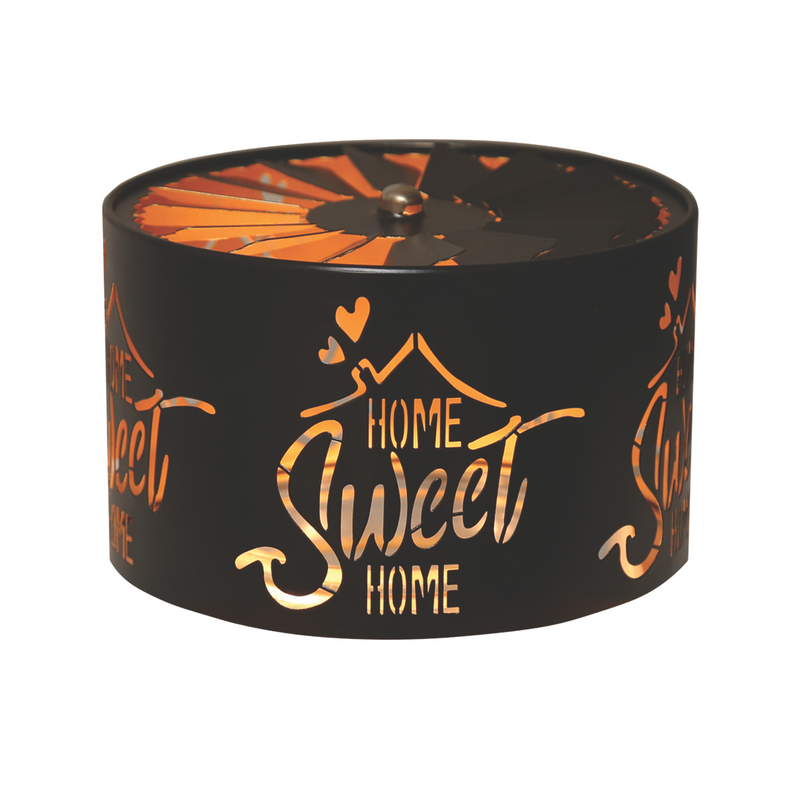 Elegant black cylindrical candle jar spinning shade carousel with features cut-out text "Home Sweet Home" with heart accents. Warm light glows through the designs, creating a serene and decorative ambiance.