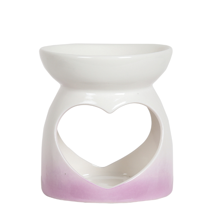 White ceramic wax melt burner with a heart shape cutout, featuring a soft pink gradient at the base. The design conveys elegance and simplicity.