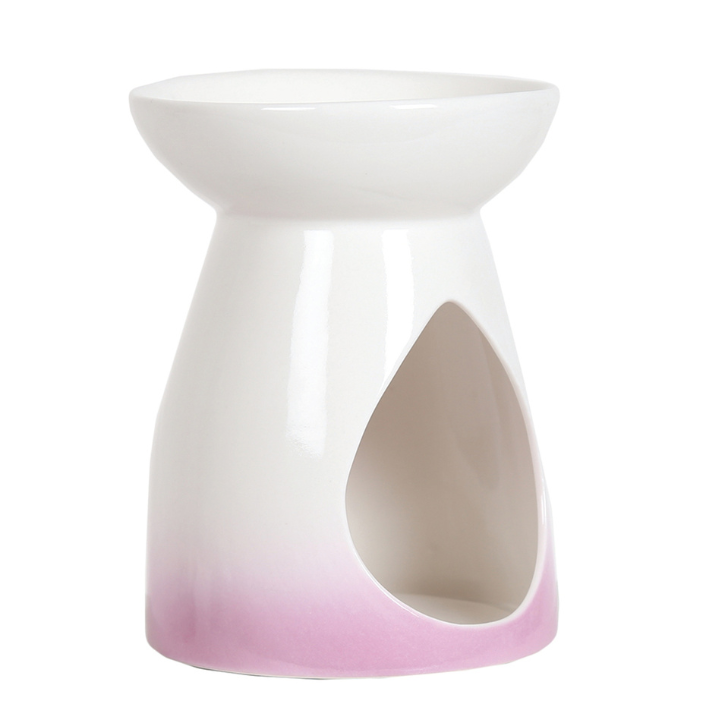 White ceramic wax melt burner with a teardrop cutout, featuring a soft pink gradient at the base. The design conveys elegance and simplicity.
