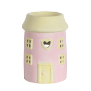 Ceramic wax melt warmer shaped like a pink house. Features include square windows, a heart-shaped cutout, and a front door design