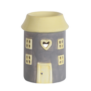 Ceramic wax melt warmer shaped like a grey house. Features include square windows, a heart-shaped cutout, and a front door design