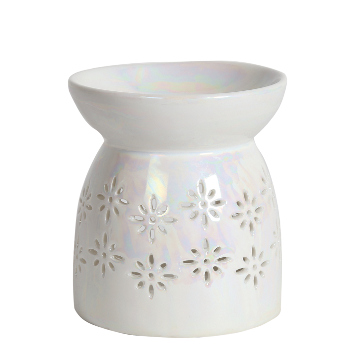 Elegant white ceramic oil burner with a glossy finish, featuring cut-out daisy patterns. The design is simple and evokes a calming, decorative feel.