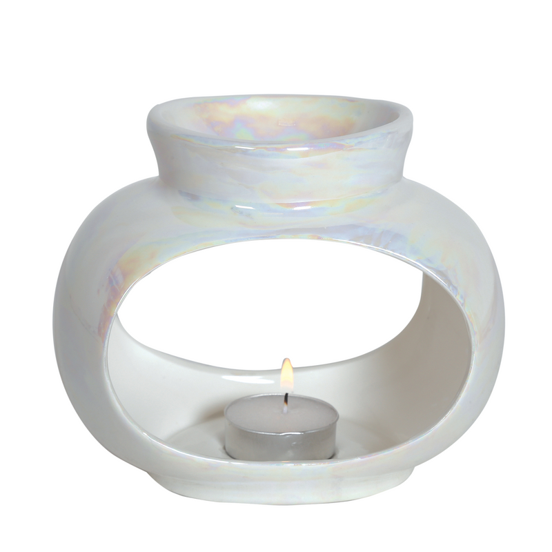Iridescent white ceramic oil burner with a curved open design, holding a lit tealight candle in the center. Soft, calming glow and elegant appearance.
