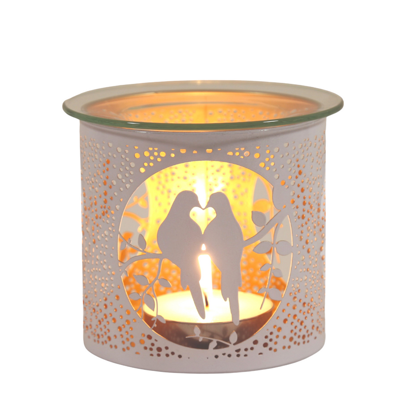 Candle holder with cutout silhouette of two doves on a branch, casting a warm glow. Perforated design adds texture, creating a cozy and romantic ambiance.