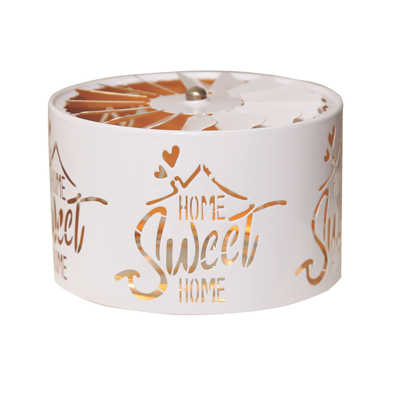 Elegant white cylindrical candle jar spinning shade carousel with features cut-out text "Home Sweet Home" with heart accents. Warm light glows through the designs, creating a serene and decorative ambiance.