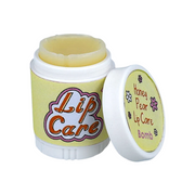 Lip care product in a container featuring a twist-off cap. The container is predominantly yellow with the words "Lip Care" in bold, colorful lettering on the front. The cap is slightly open, revealing a pale yellow lip balm inside. Next to it, a smaller lid displays the text "Honey Pear Lip Care Bomb" along with a floral design. The overall design suggests a playful and soothing lip care product.