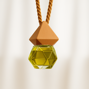 Geometric Car Fragrance Diffuser with yellow-colored, hexagonal bottle, suspended from a brown twisted cord. Minimalist and elegant design.