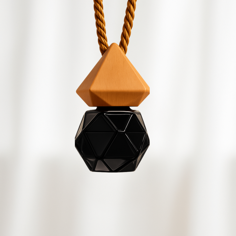 Car Fragrance Diffuser with a geometric black bottle hangs on a brown cord on a white background.