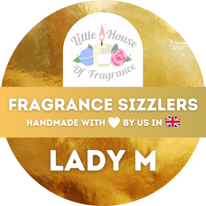 A gold circular label with a logo showing a candle, flowers, and text "Little House of Fragrance." Text reads "Fragrance Sizzlers, Handmade with ♥ by us in 🇬🇧, Lady M."