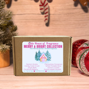 Box of Little House of Fragrance Merry & Bright Collection on a wooden surface with Christmas decorations.