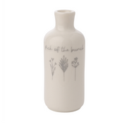 A white ceramic mini vase featuring minimalist sketches of three flowers and the phrase "Pick of the bunch." The design conveys simplicity and elegance.