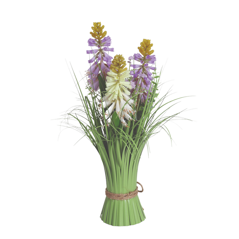 A bouquet of green grass-like leaves with three cone-shaped flowers, featuring purple, white, and yellow hues, tied with a brown rope. Bright and fresh tone.