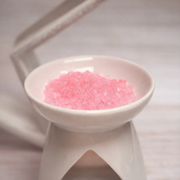 Pink fragrance sizzlers in wax warmer dish ready to melt and release fragrance